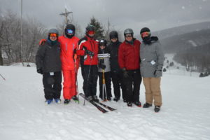 Photo of six skiiers with a snowy background