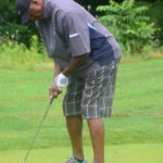 a man putting on a golf course